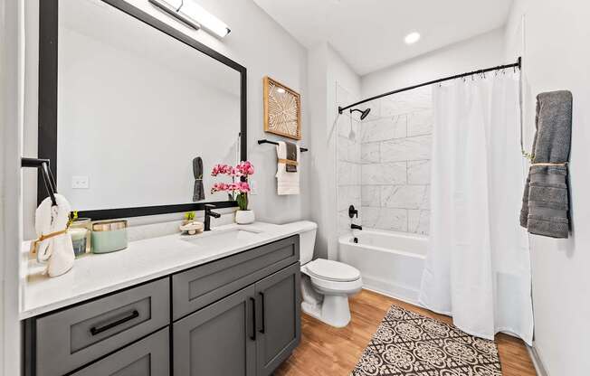 A bathroom with a white toilet and a white shower curtain