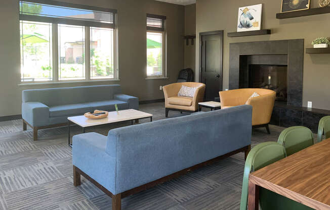 a living room with couches chairs and a fireplace