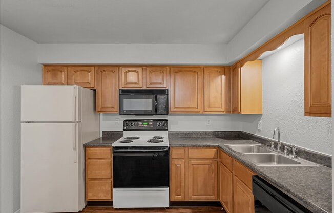 a kitchen with a stove refrigerator and sinkat Millcreek Woods Apartments, Kansas, 66061