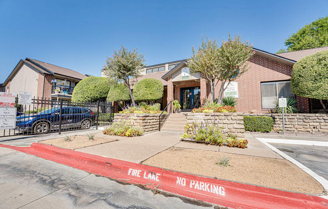A red fire lane no parking zone in front of a building.
