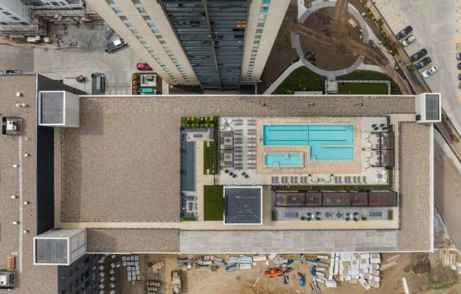 a view from above of a large building with a pool on top of it