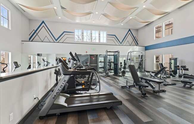 Gym with treadmills and other exercise equipment in a building with large windows at Windsor Westminster, Westminster, Colorado