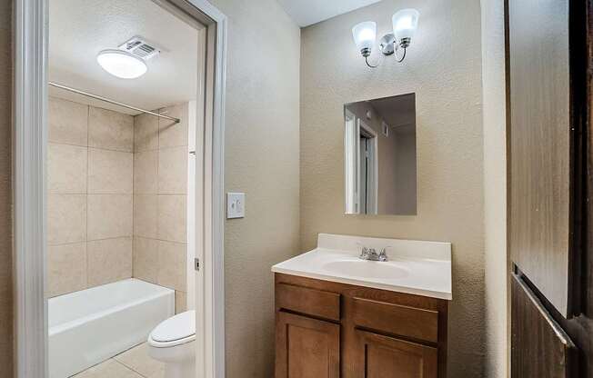 A bathroom with a white sink, a white toilet, and a white bathtub.