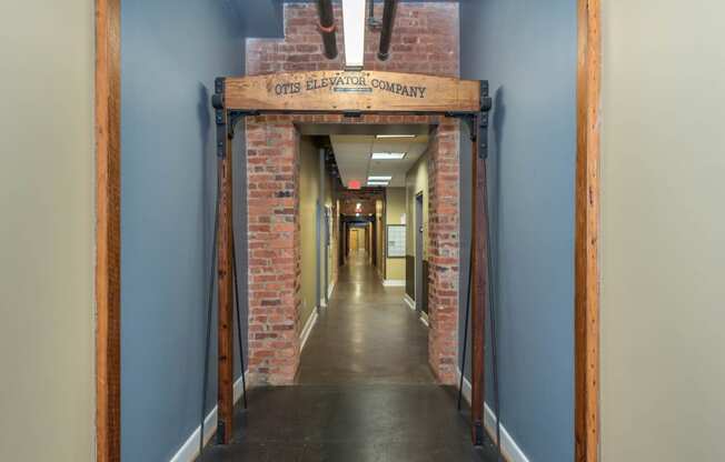 a hallway with a brick doorway with a sign above it at Mayton Transfer Lofts, Petersburg