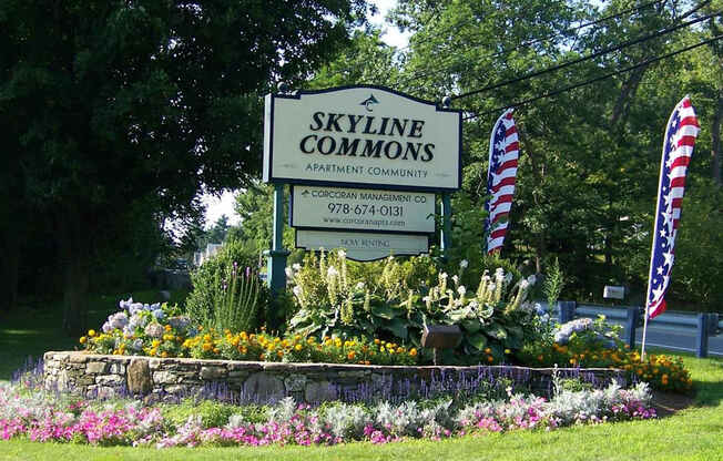 A sign for Skyline Commons Apartment Community with a phone number and website.