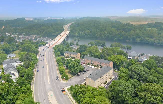 an aerial view of a highway and a bridge over a river