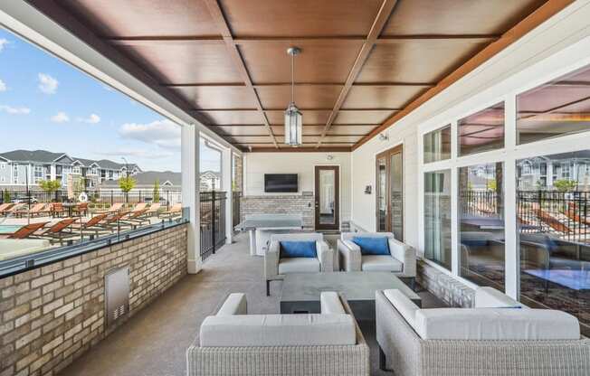 a living room with couches and chairs and a balcony