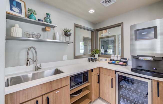 A kitchen with a sink, microwave, and refrigerator.