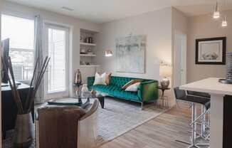 Open living area with stylish plank flooring throughout the space and large windows.