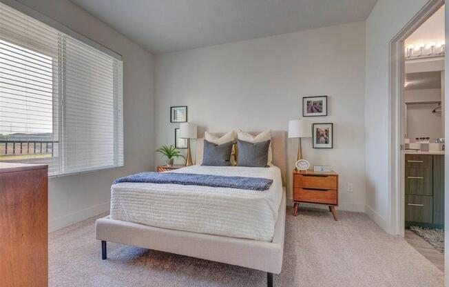 a bedroom with a bed and a closet  at Affinity 56 Apartments in West Jordan, Utah