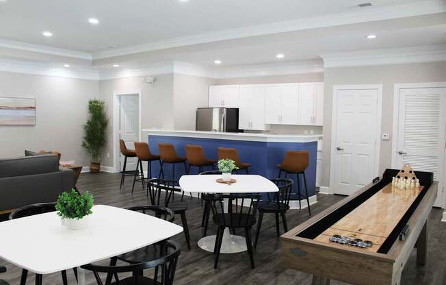 A room with a table, chairs, and a shelf with a plant on it.