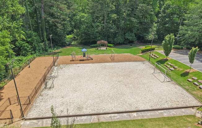 A  play area with goals, playground, and dog park