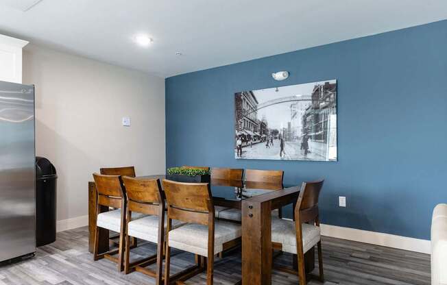 A dining room with a wooden table and chairs.
