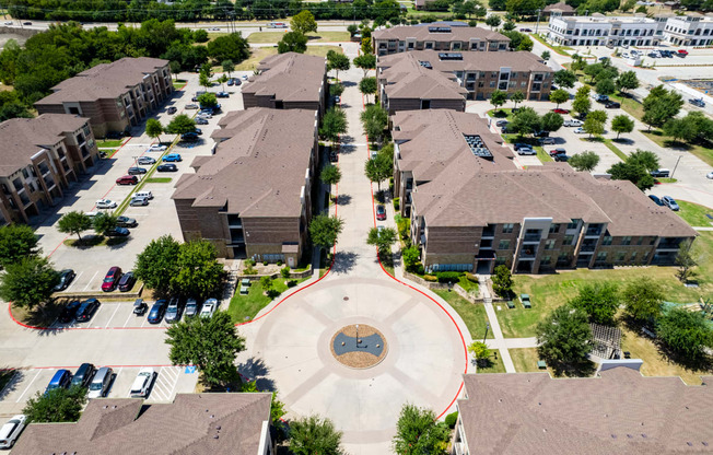 an aerial view of a neighborhood with houses and buildings and a circle in the middle at Discovery at Craig Ranch, McKinney, 75070