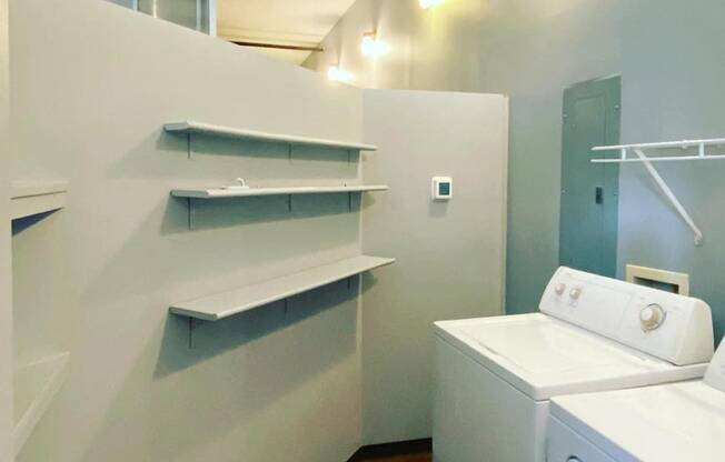 large laundry room with built-in shelving and appliances at Jemison Flats, Birmingham