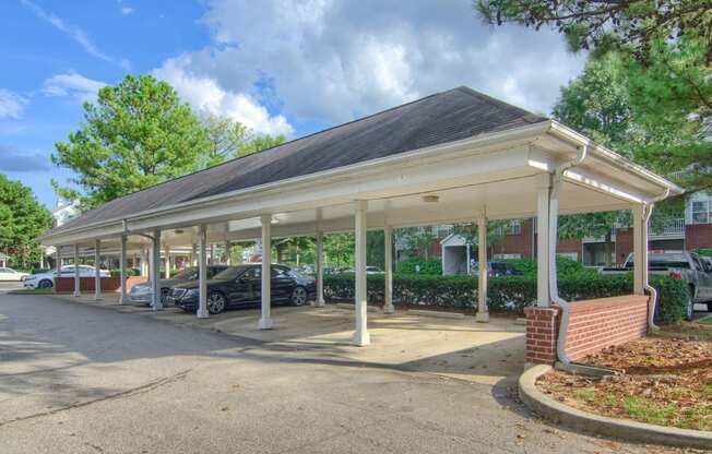 Enclave at Wolfchase Apartments in Cordova Tennessee photo of a covered parking lot with cars parked under it