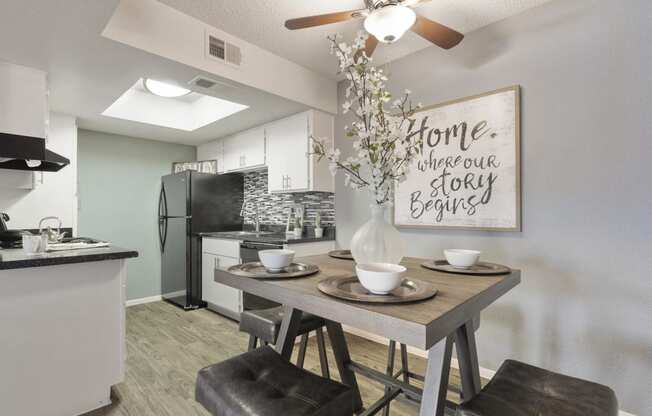 an open kitchen and dining area with a table and chairs