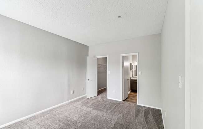 a spacious living room with carpet and white walls