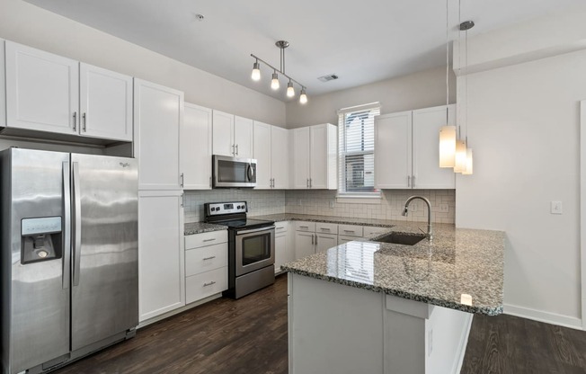 a kitchen with stainless steel appliances and granite counter tops