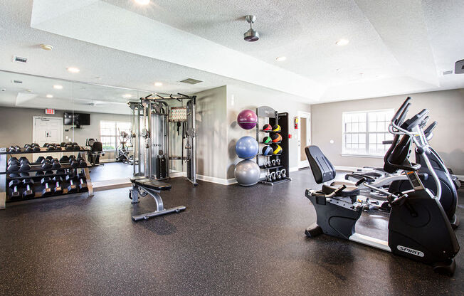 the gym at the district at highland village apartments