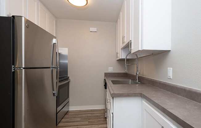 Apartments for Rent in Portland, OR - Ellinwood Kitchen with Stainless Steel Appliances, and Modern White Wood Cabinets