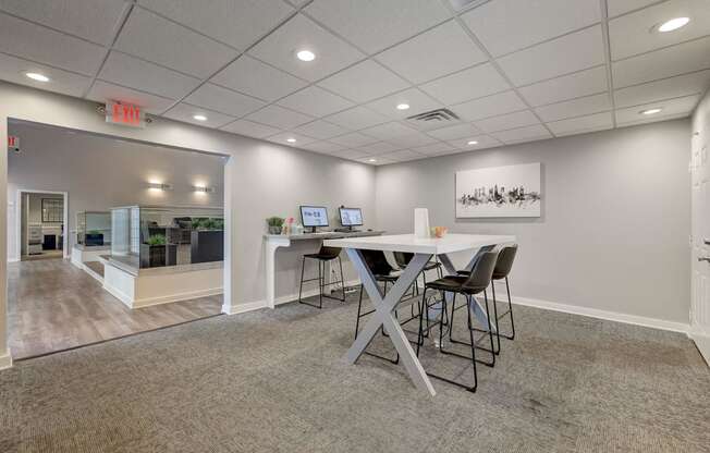 A conference room with a table and chairs.