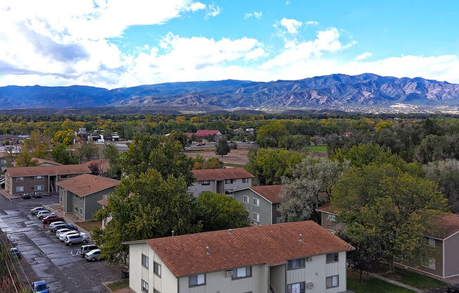 an aerial view of houses in a neighborhood with mountains in the background