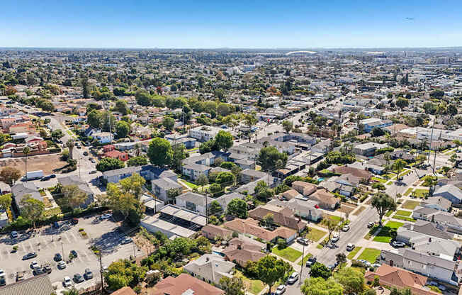 A bird's eye view of a residential area with houses and cars.