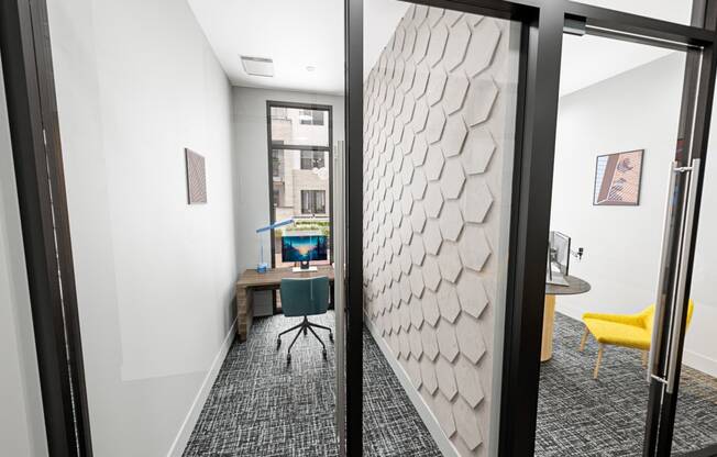 a view of a room with a desk and a door