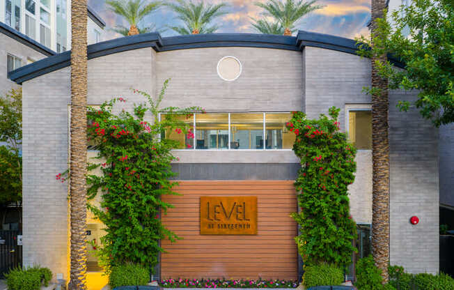 A modern building with a wooden entrance and a sign that reads "LEVEL".