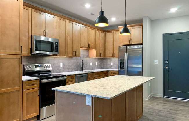 A kitchen with wooden cabinets and a granite countertop.