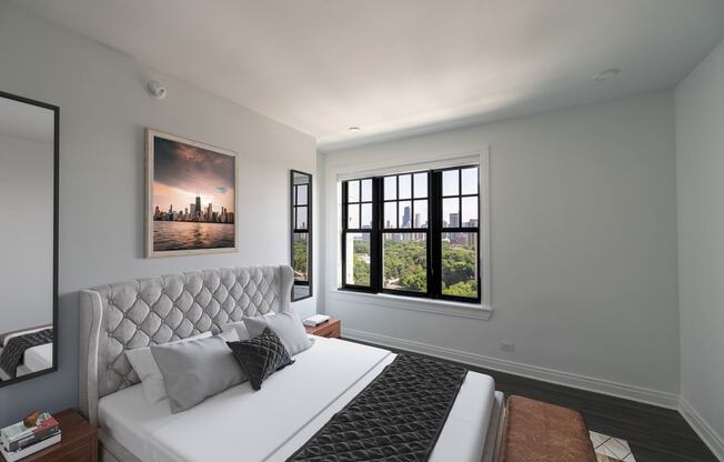 a bedroom with a white bed and a large window  at The Belden Stratford, Chicago, IL