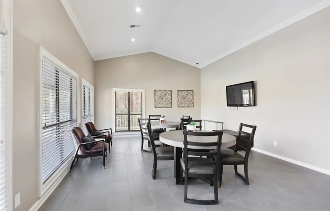 A dining room with a table set for four.