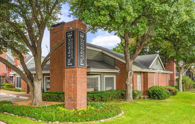 an apartment building with a sign in front of it