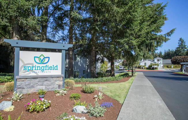 Exterior entry with trees and other plants.  There is a Springfield welcome sign.at Springfield, Renton, WA