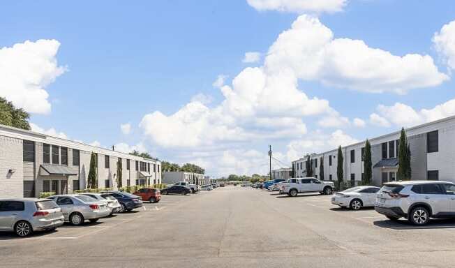 an empty parking lot with rows of buildings on both sides of it at Brookside Apartments, Hewitt, TX