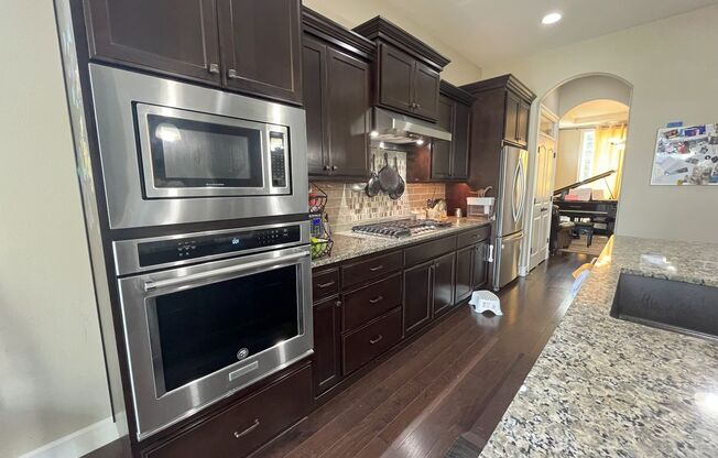 Stylish 5-Bedroom Home with Modern Kitchen, Stone Fireplace & Luxurious Primary Suite