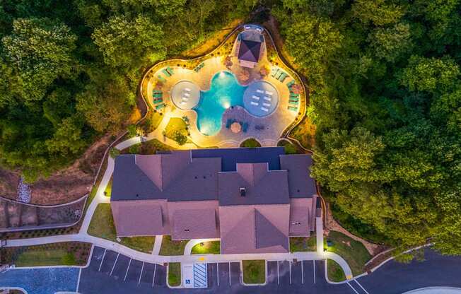 a birdseye view of a house with a pool and trees