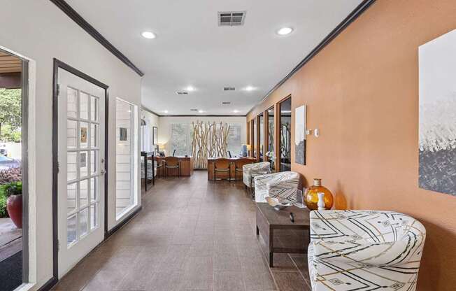 A long hallway with a bench and chairs on the right side.