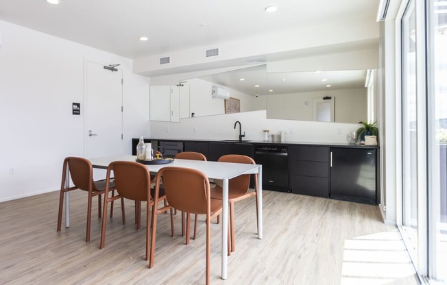 a dining room and kitchen with a table and chairs at Analog PDX, Oregon