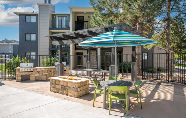 our apartments have a patio with a table and chairs and an umbrella