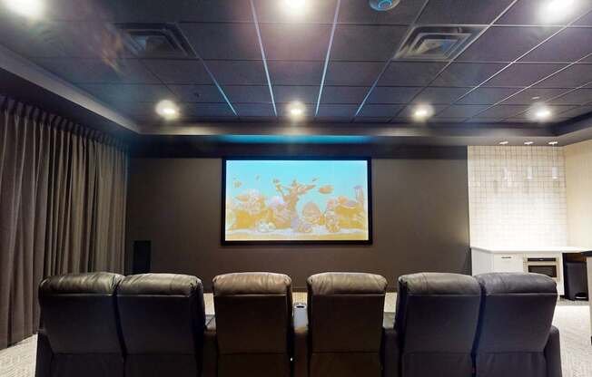 a conference room with a projector screen and chairs