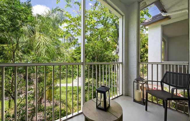 a balcony with a view of a yard and trees