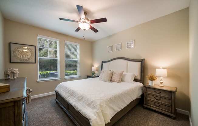 a bedroom with a large bed and a ceiling fan