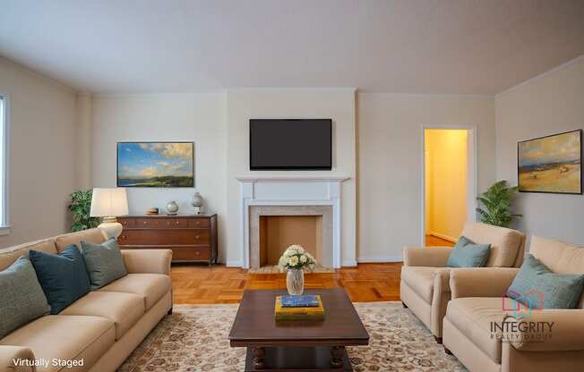 A living room with a couch, coffee table, and a painting on the wall.