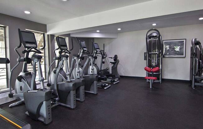 Large fitness center with modern workout equipment at Camelot East Apartments, Fairfield, OH