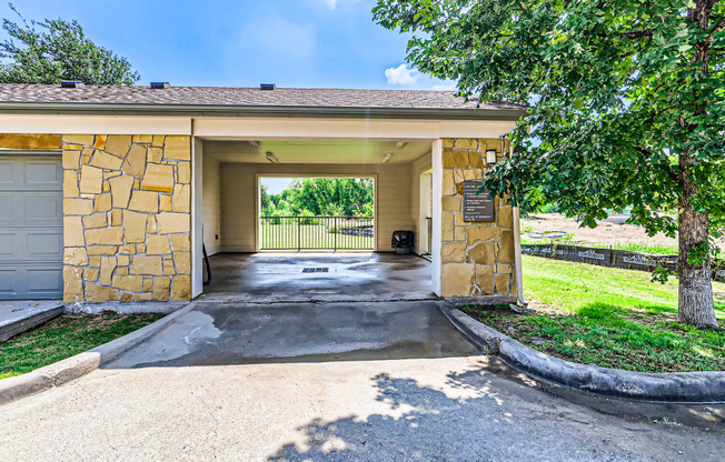 the front entrance of a house with a driveway and tree at Discovery at Craig Ranch, Texas, 75070