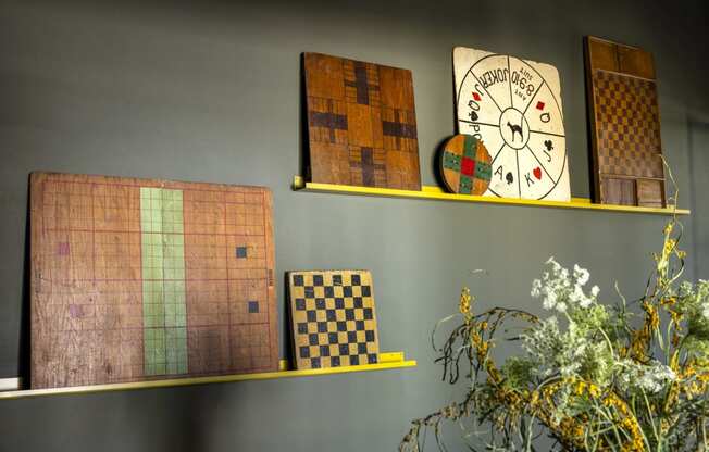a shelf with a clock and games on it
