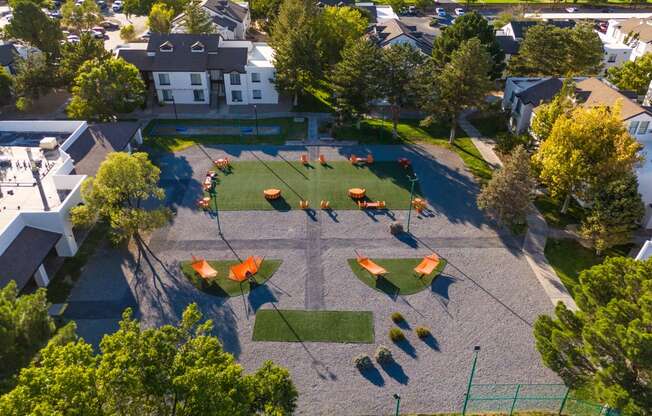 an aerial view of a playground in a neighborhood with trees