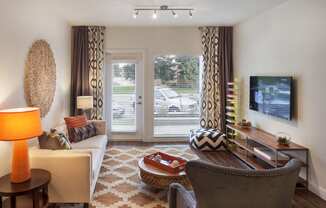 a living room with a couch and a chair and a television